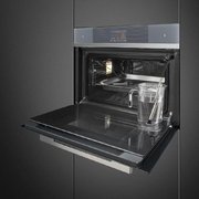 Компактный духовой шкаф с пароваркой Smeg SF4104WVCPS фото 2 в Челябинске